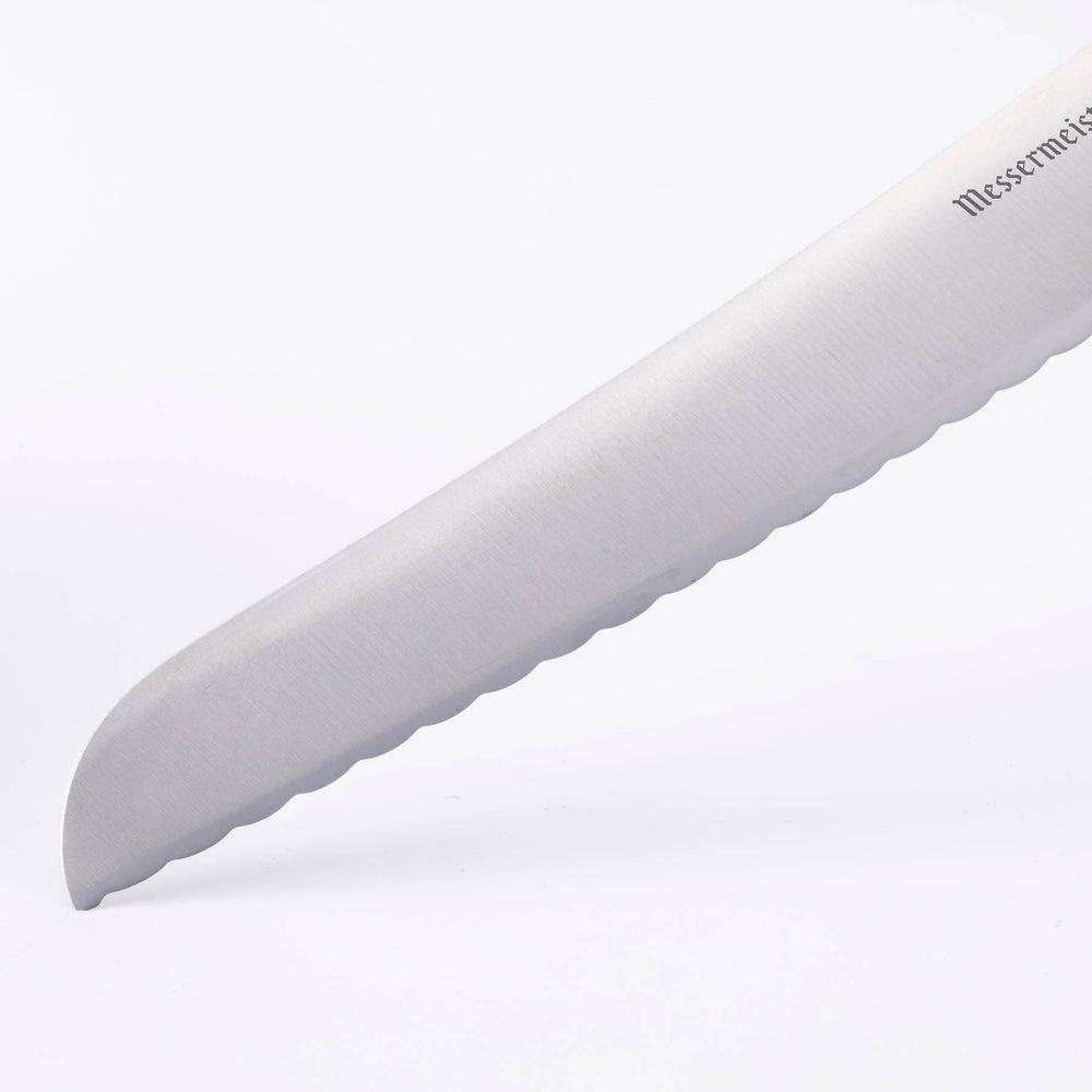 Close up of the Oliva Elite 6 inch Reverse Scallop Utility Knife tip showing reverse scalloped edge