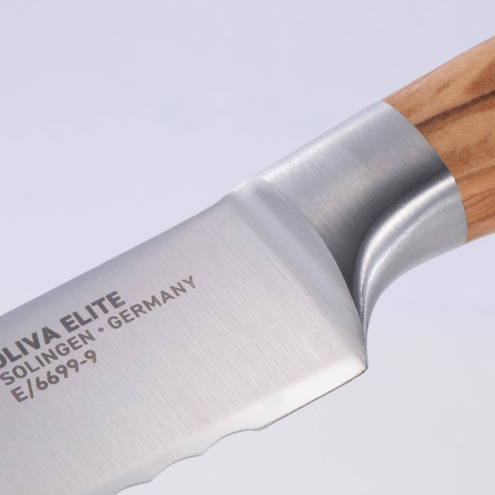 Close up view of the Oliva Elite 9 inch serrated bread knife tip showing the bolster and heel