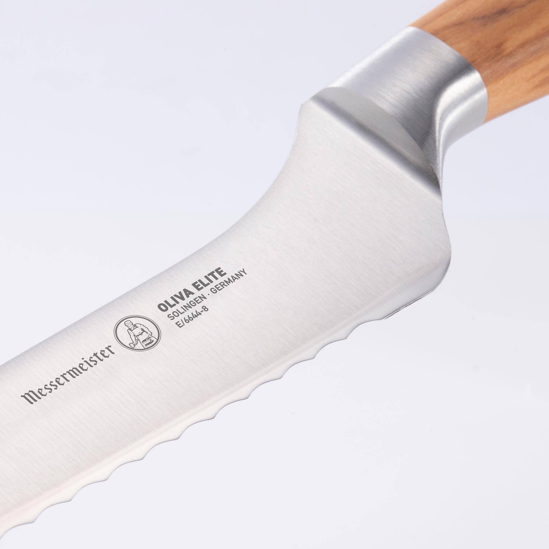 Close up of the 8 inch Oliva Elite Offset Scalloped Bread Knife bolster and heel