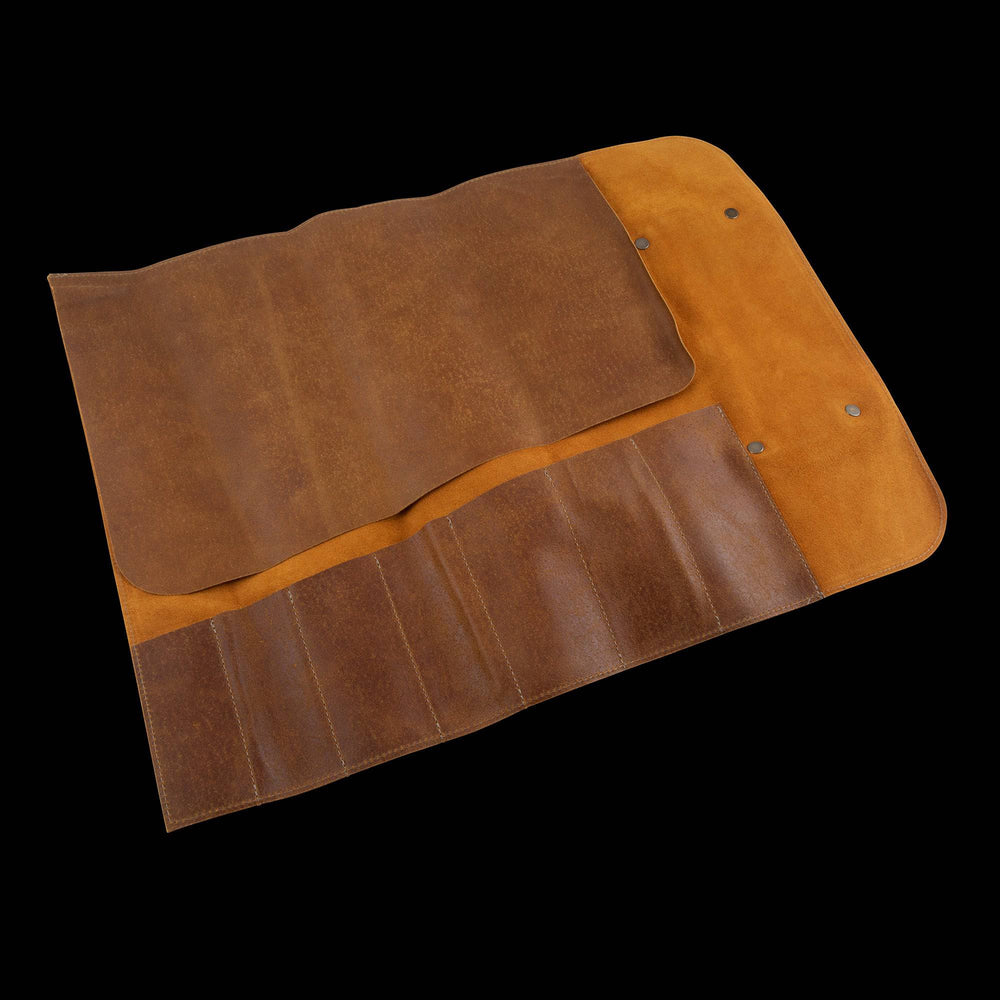 Interior view of the Messermeister Vintage Leather 7 Pocket Knife Roll in amber brown, displaying seven spacious knife pockets with durable canvas lining, reinforced stitching, protective flaps, and organized storage designed to securely hold chef knives and culinary tools
