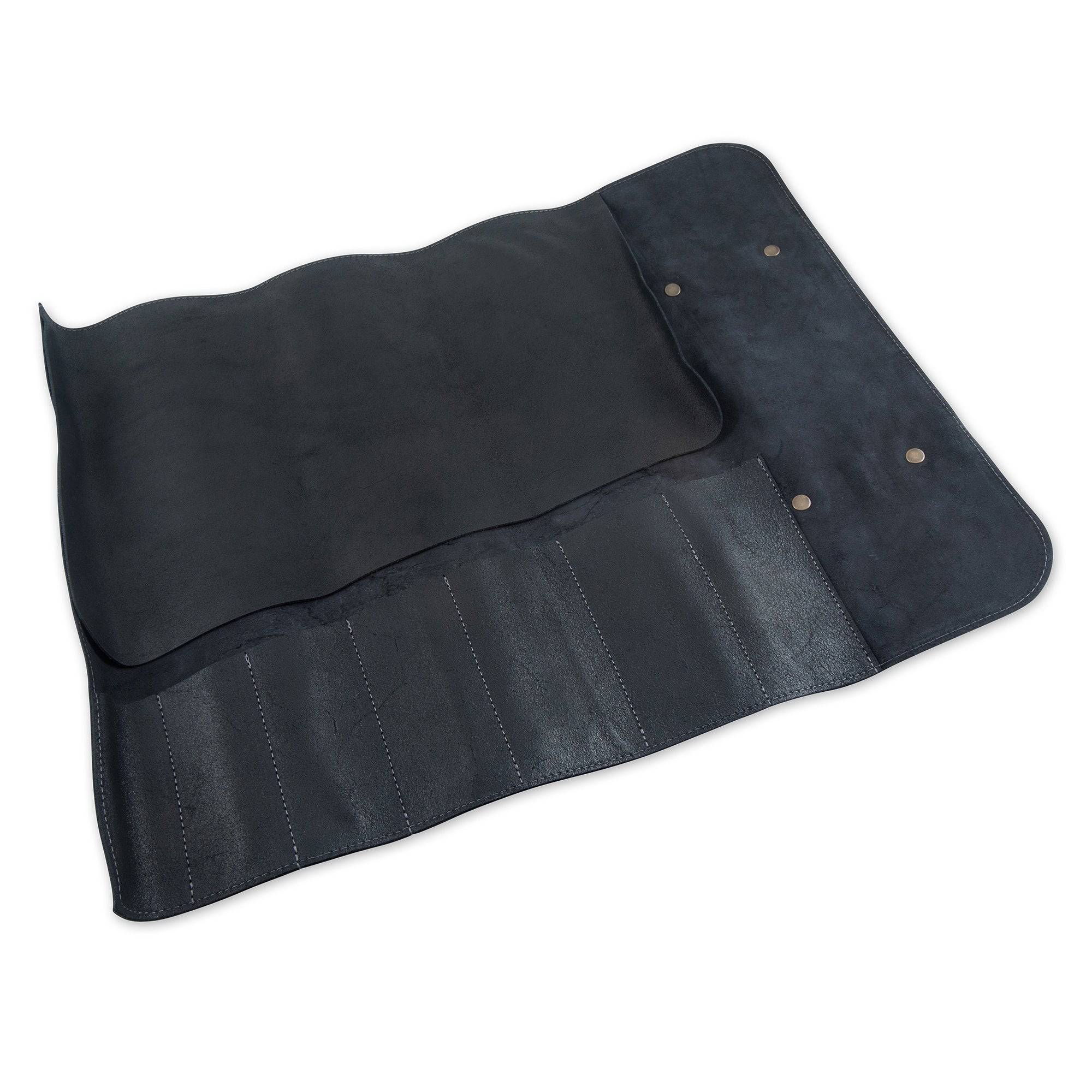 Interior view of the Messermeister Vintage Leather 7 Pocket Knife Roll in black, displaying seven individual knife slots with durable canvas lining, reinforced stitching, protective flaps, and organized storage compartments designed to securely hold chef knives and culinary tools