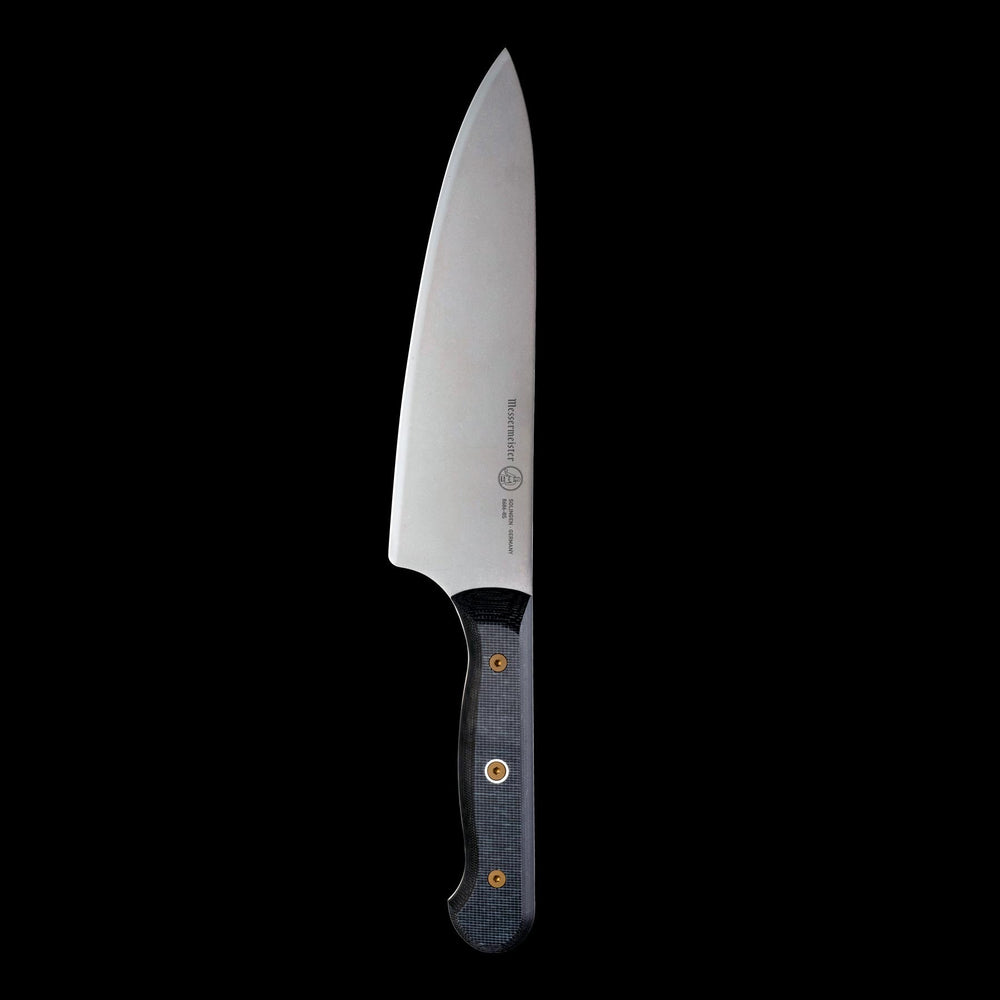 Close-up of Messermeister custom chef’s knife showing complete blade profile and handle construction